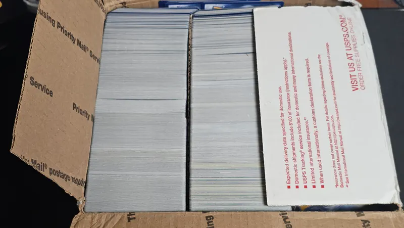 Sorted Pokémon bulk packed in rows inside a Priority Mail flat rate box